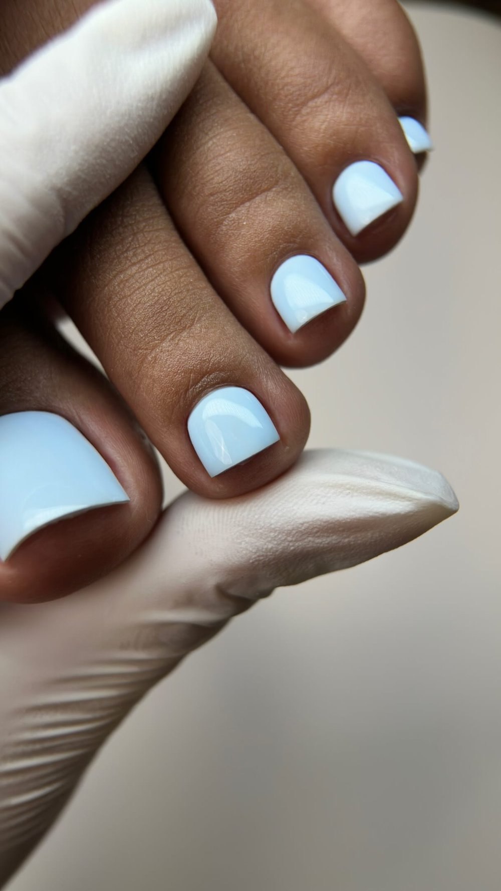 Finished white polish on a client's toes